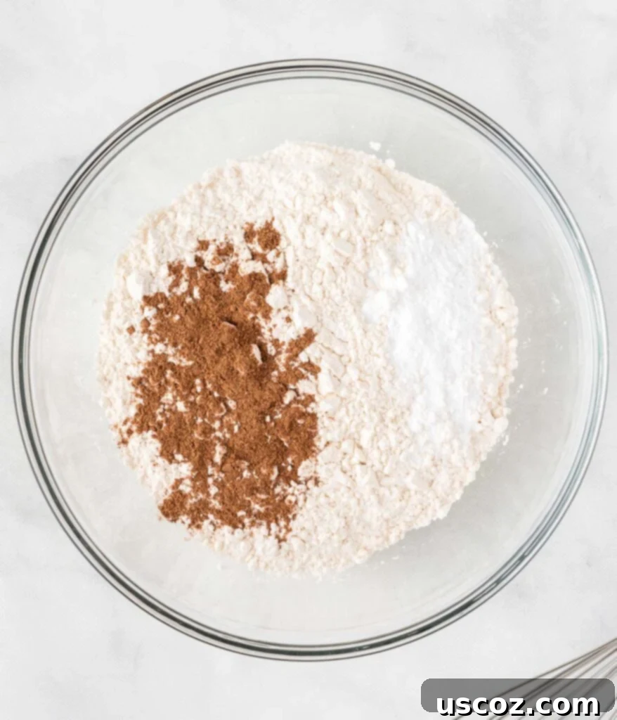 Bite-Sized Pumpkin Delights 6 Dry ingredients like flour, baking soda, and pumpkin pie spice in a white mixing bowl.