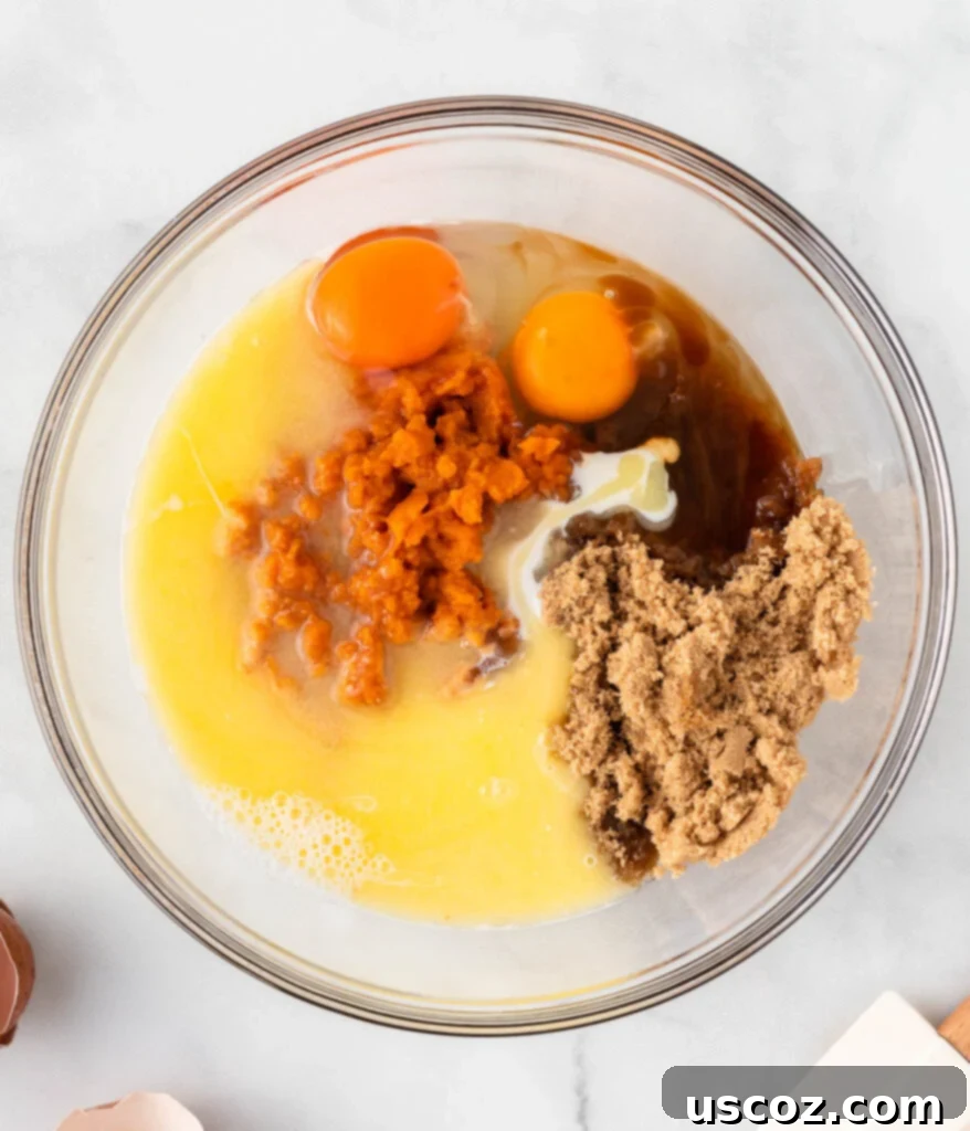 Bite-Sized Pumpkin Delights 8 All wet ingredients, including pumpkin, butter, vanilla, brown sugar, milk, and eggs, in a mixing bowl.