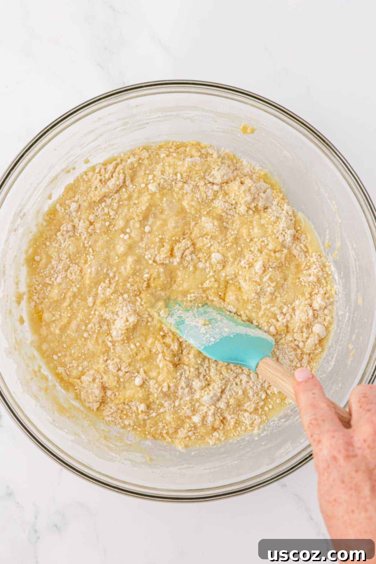 Bakery-Style Chocolate Chip Muffins from a Box 7 folding the cake mix into the batter