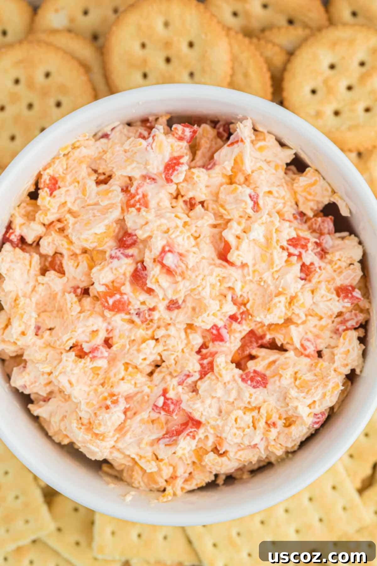 Pimento Cheese 8 A large bowl of freshly made homemade pimento cheese, showcasing its rich orange color and creamy texture, ready to be chilled.