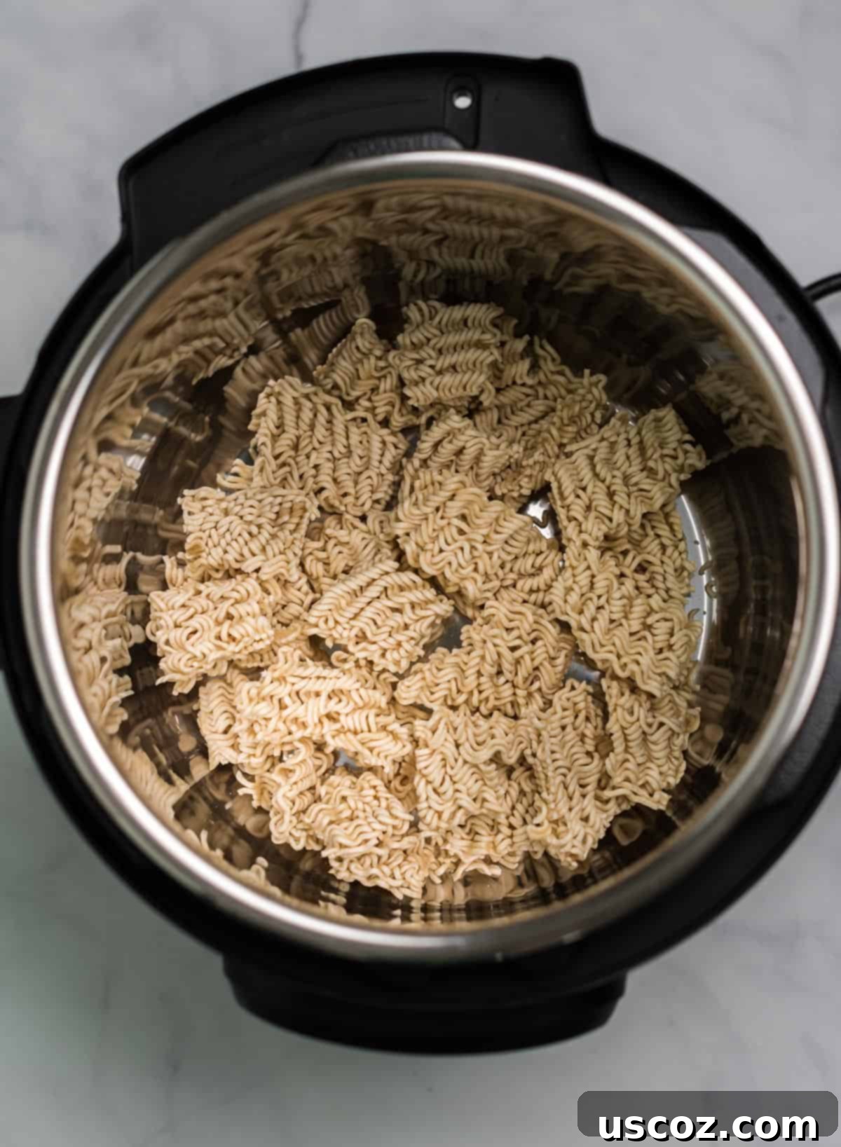 Effortless Instant Pot Stir Fry 4 ramen noodles broken up inside an instant pot