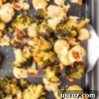 Golden Roasted Broccoli and Cauliflower 11 Spatula taking roasted broccoli and cauliflower from the pan, golden brown and perfectly cooked.