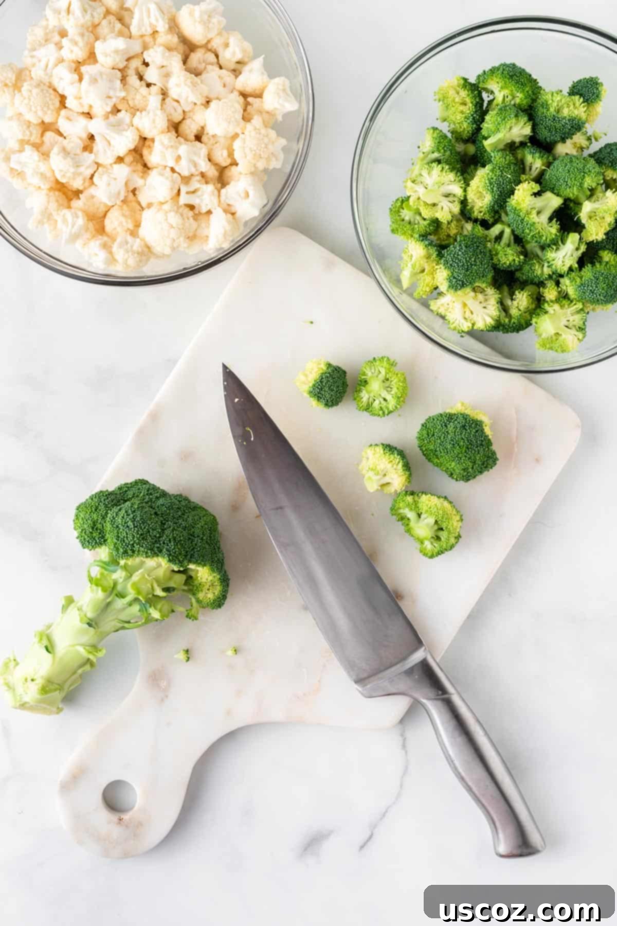 Golden Roasted Broccoli and Cauliflower 4 A hand expertly cutting fresh broccoli into uniform florets on a wooden cutting board, preparing them for the roasting process.