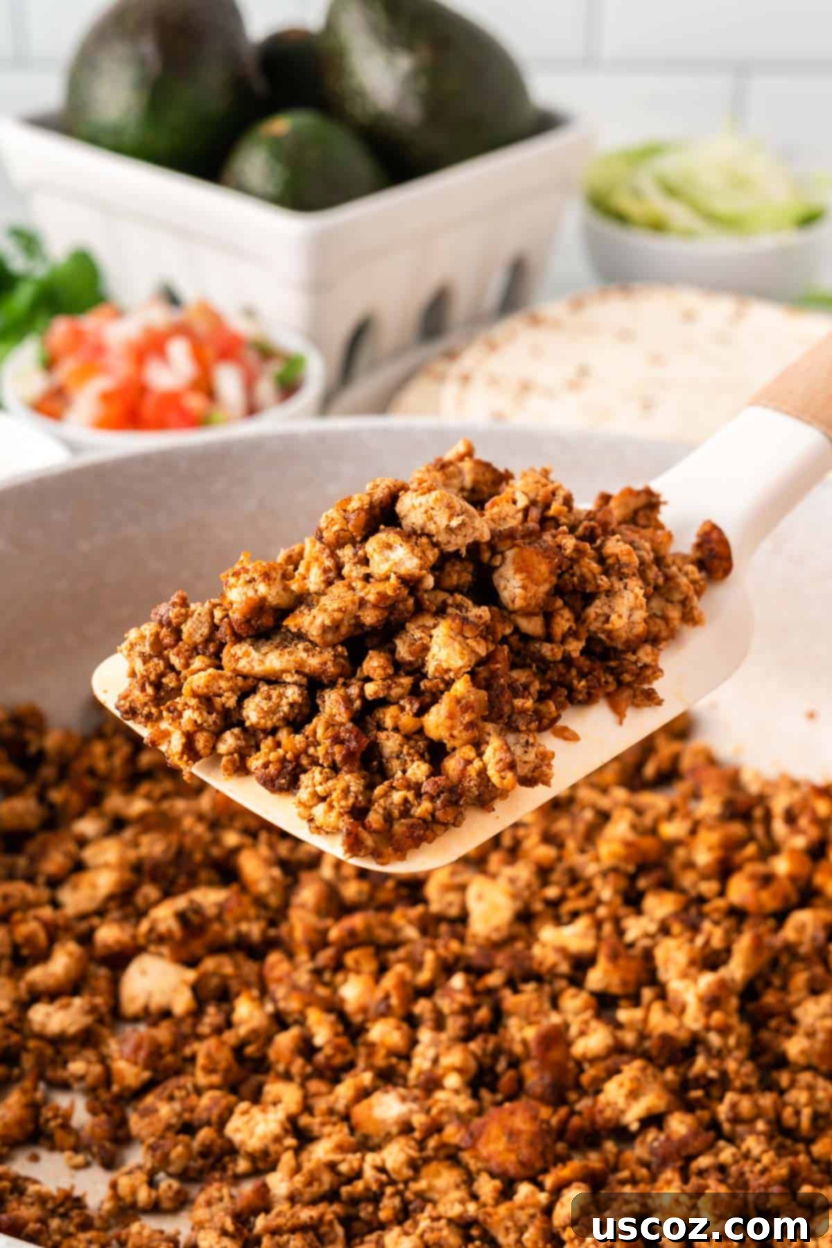 Zesty Tofu Tacos 3 spatula taking tofu taco crumbles from the pan