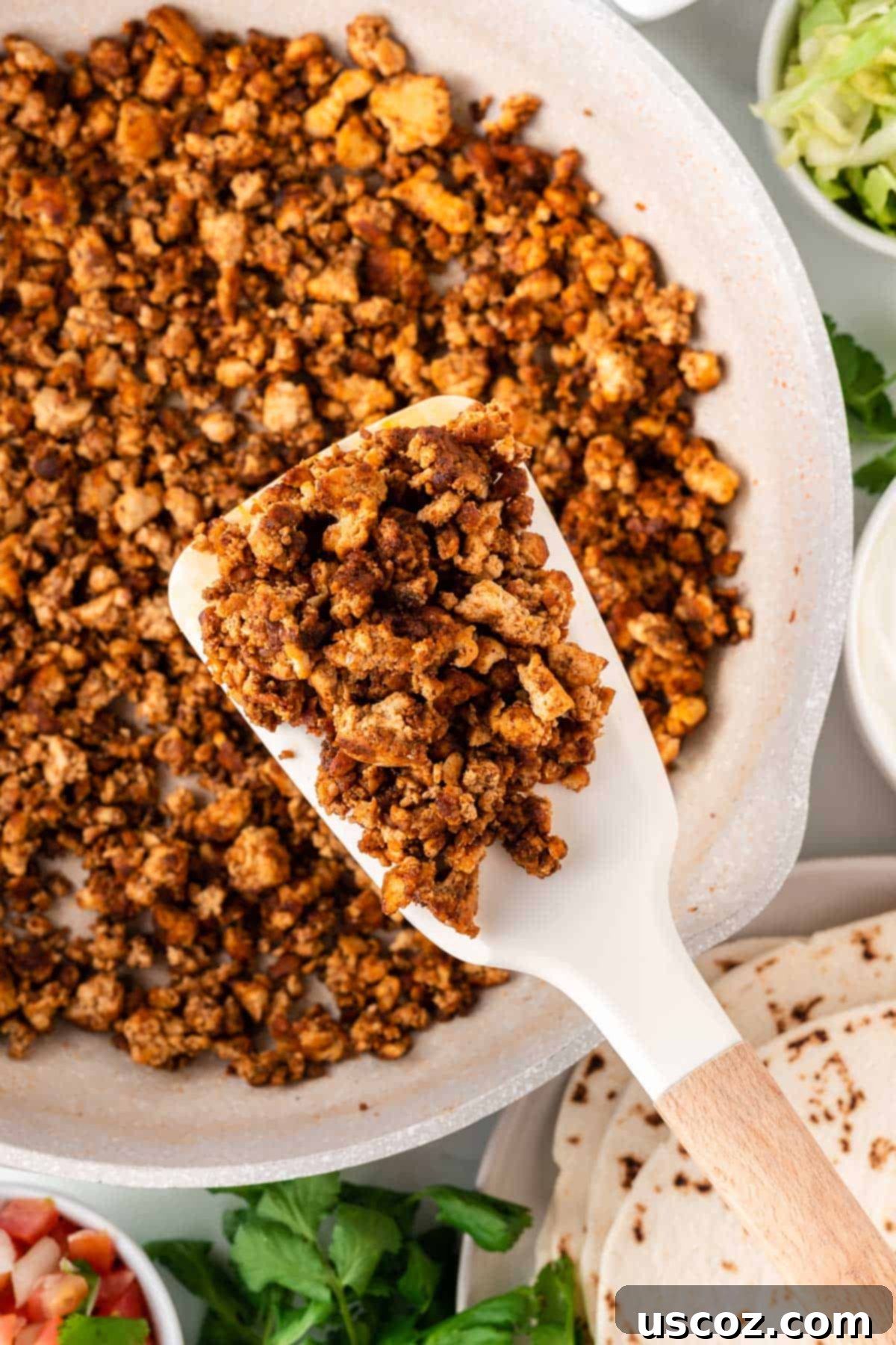 Zesty Tofu Tacos 8 spatula taking tofu taco crumbles from the pan
