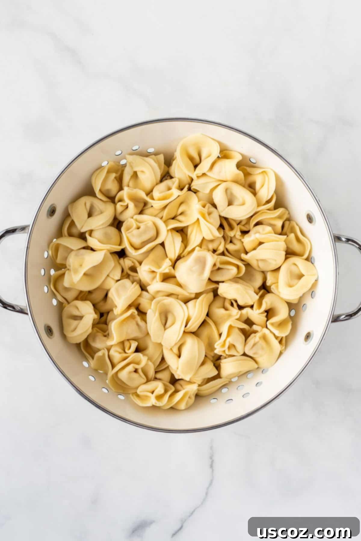Zesty Tortellini Medley 5 cooked tortellini being rinsed with cold water in a colander