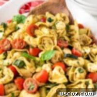 Zesty Tortellini Medley 10 serving tortellini pasta salad with a wooden spoon