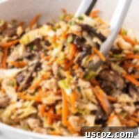 Easy Vegetarian Egg Roll Bowl 11 tongs taking egg roll filling from the skillet