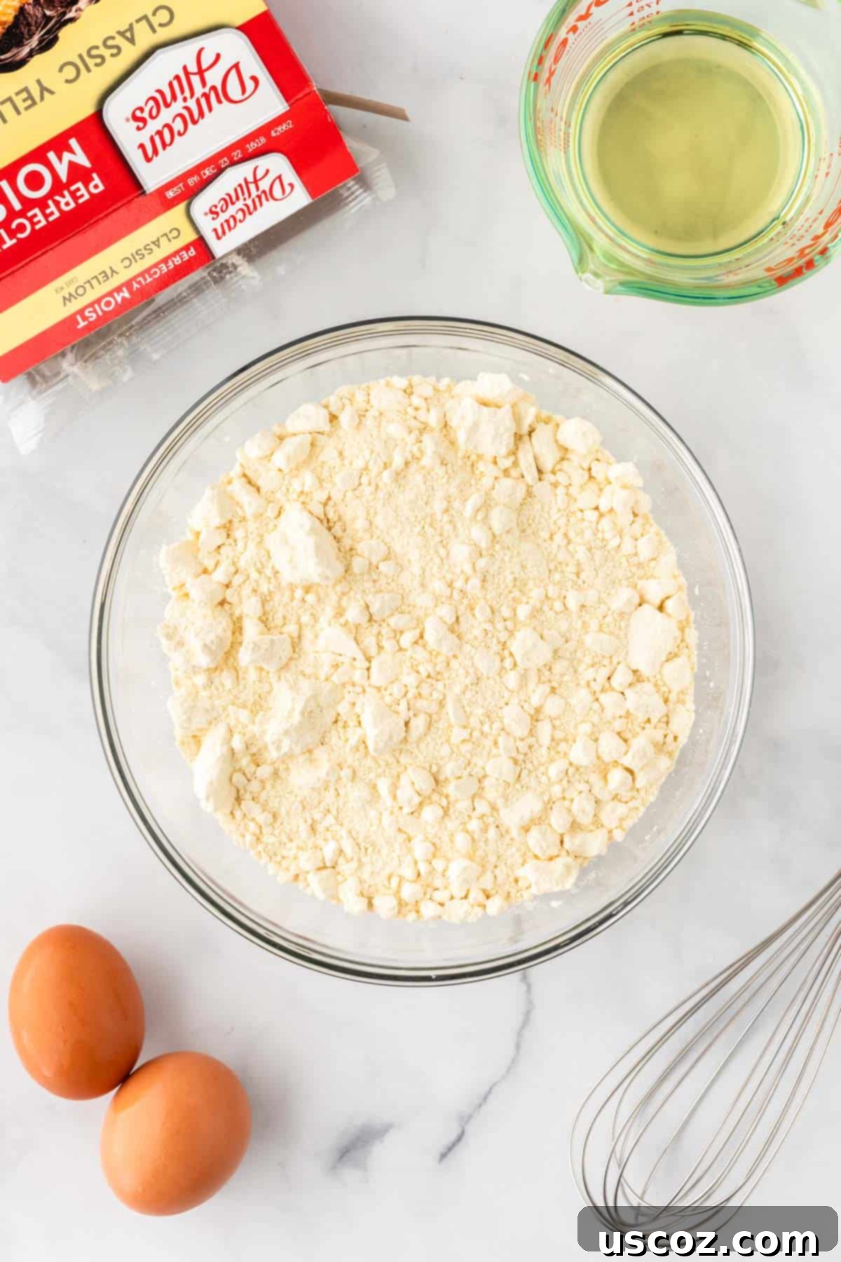 Effortless Cake Mix Snickerdoodles 5 A bowl filled with yellow cake mix, ready for ingredients to be added