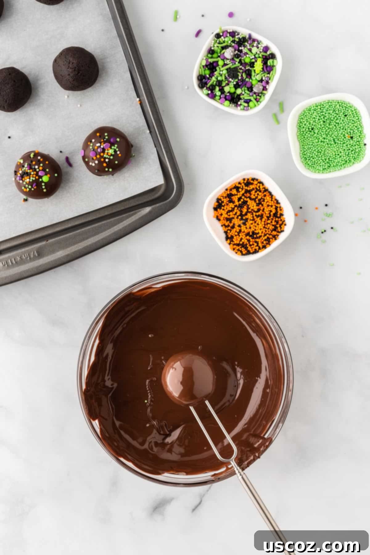 Spooky Oreo Truffles 12 An Oreo ball being dipped into smooth, melted dark chocolate