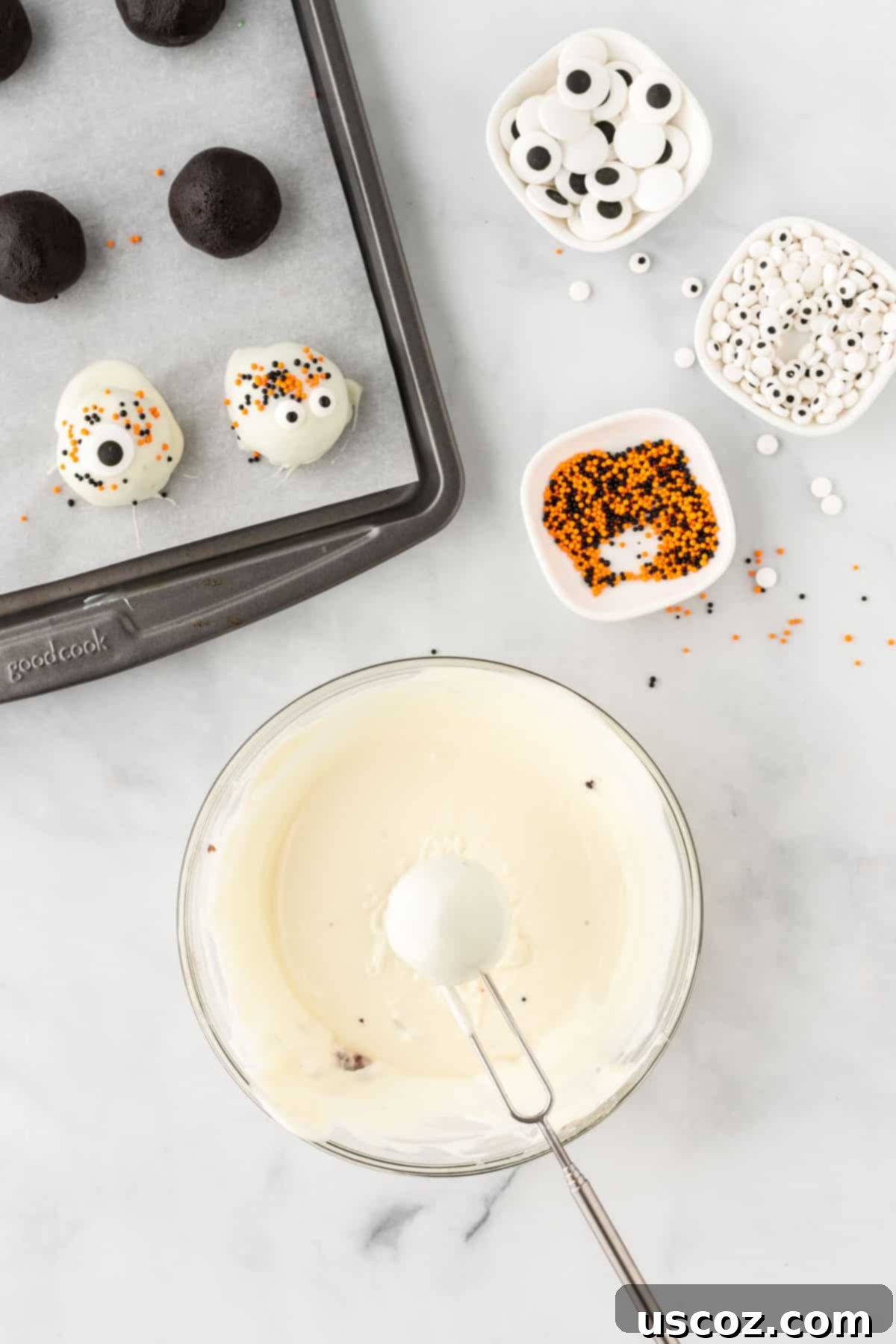 Spooky Oreo Truffles 13 An Oreo ball being dipped into smooth, melted white vanilla chocolate