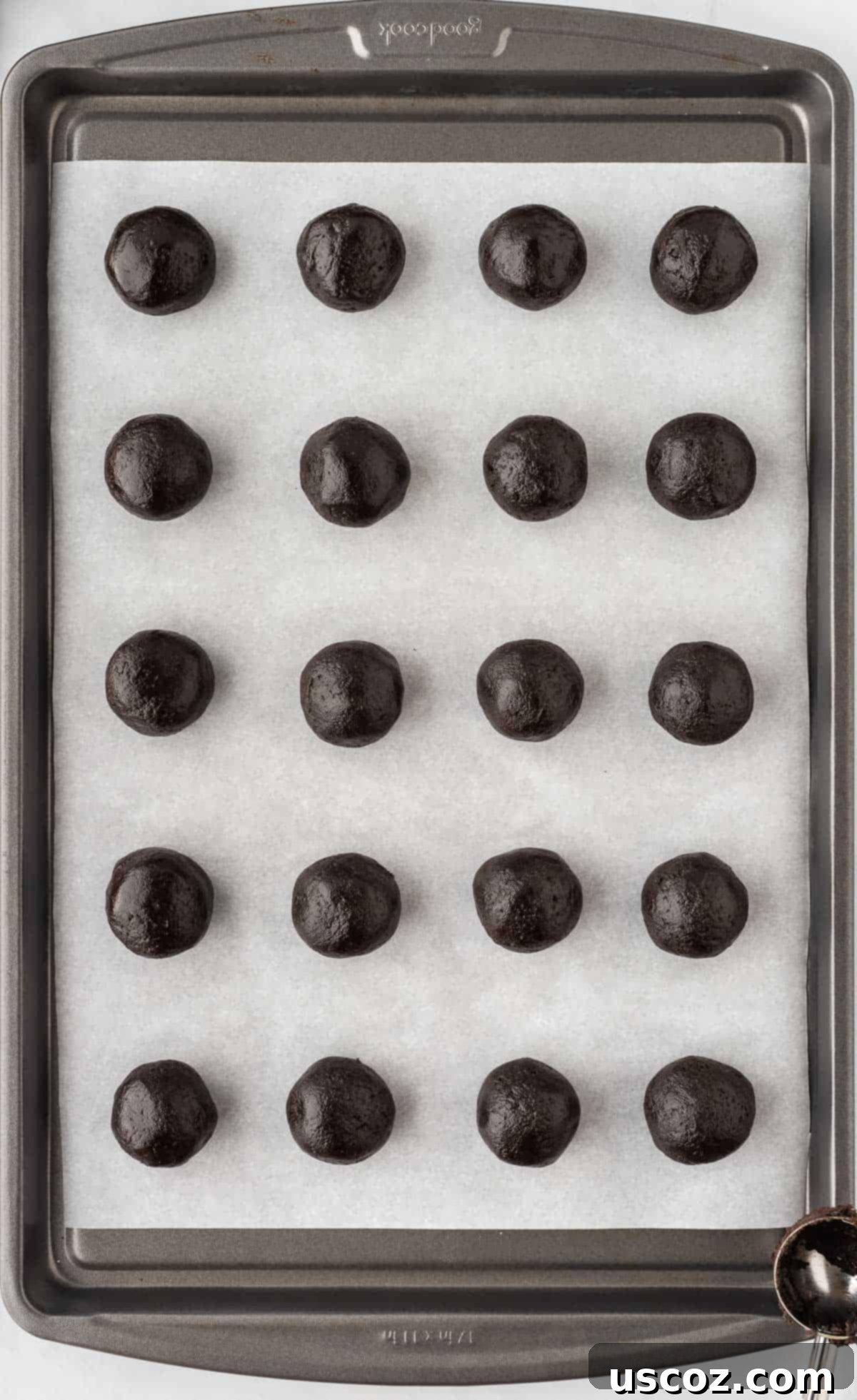 Spooky Oreo Truffles 9 Uncoated Oreo balls neatly arranged on a parchment-lined baking sheet, ready for chilling