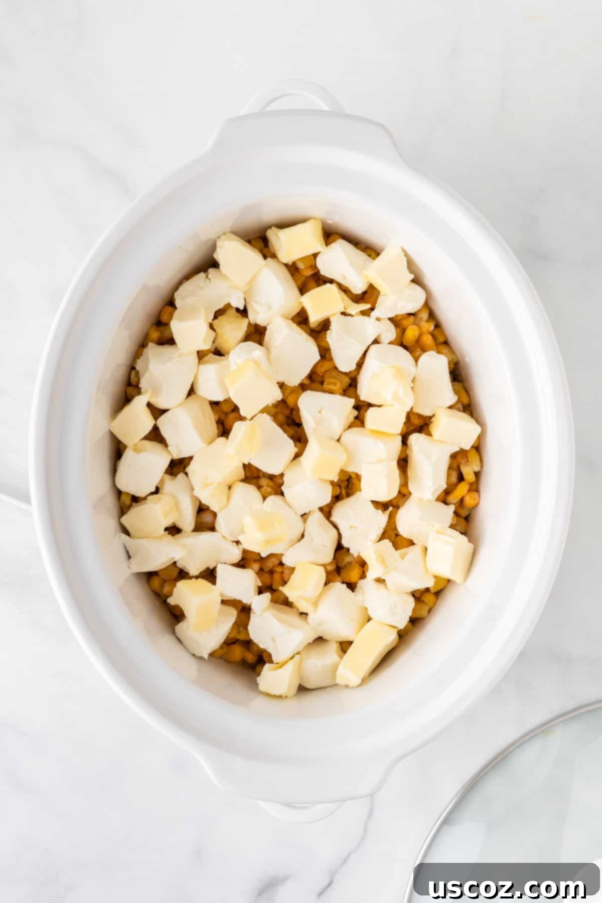 Velvety Slow Cooker Creamed Corn 7 adding butter