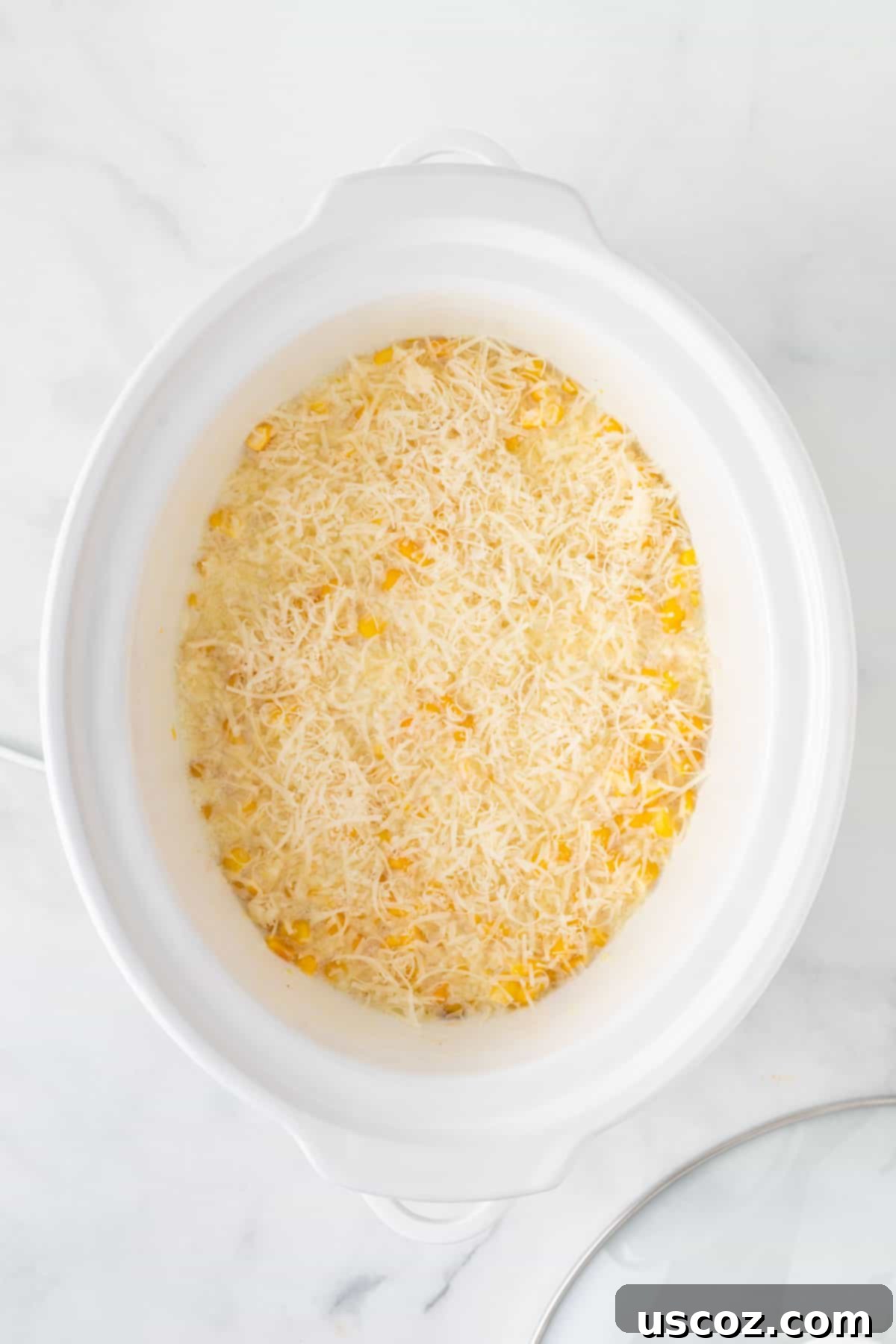 Velvety Slow Cooker Creamed Corn 9 adding parmesan cheese