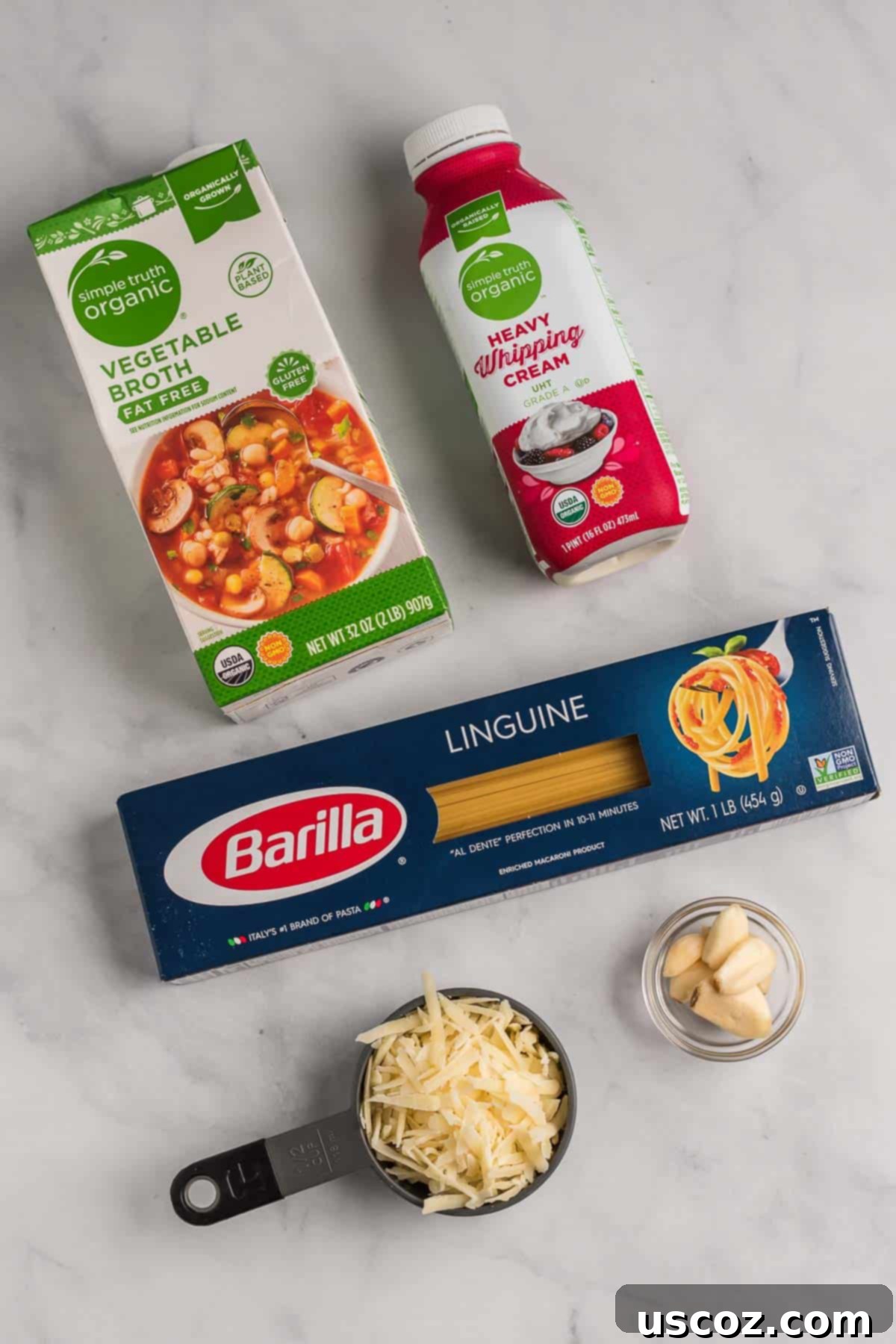 Quick and Creamy Instant Pot Pasta 4 Ingredients for Instant Pot creamy pasta laid out: linguine, broth, cream, garlic, parmesan, salt, olive oil.