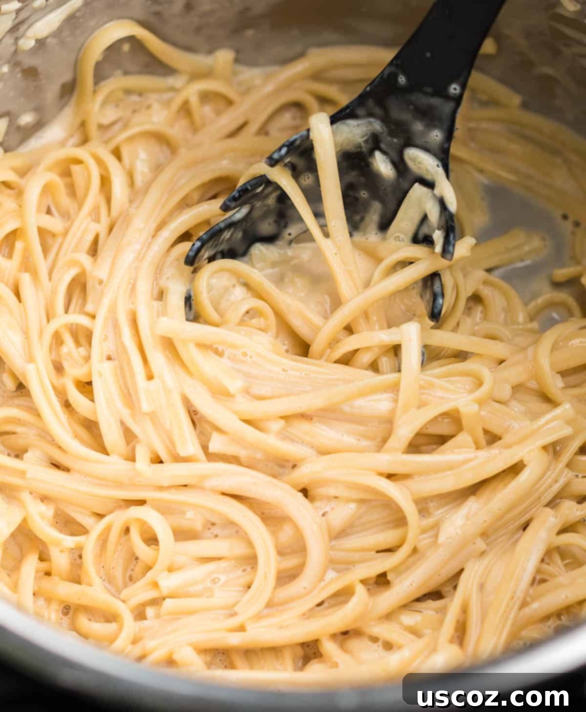 Quick and Creamy Instant Pot Pasta 8 A large pot of creamy linguine noodles in the Instant Pot, garnished and ready to serve.