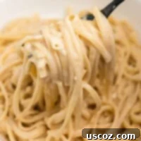 Quick and Creamy Instant Pot Pasta 10 Instant Pot creamy pasta twirled on a fork, showcasing the luscious sauce.