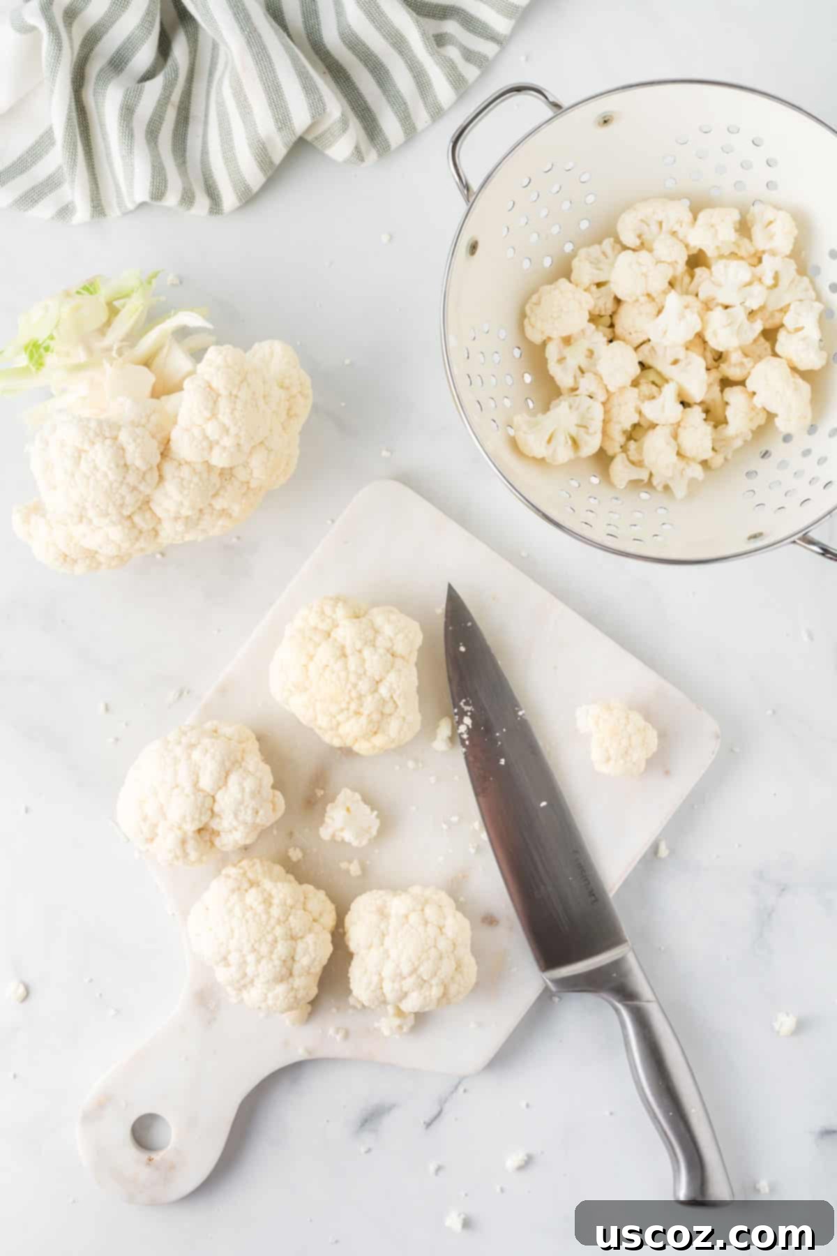 Easy Instant Pot Cauliflower 3 cutting board with cauliflower being cut with a knife