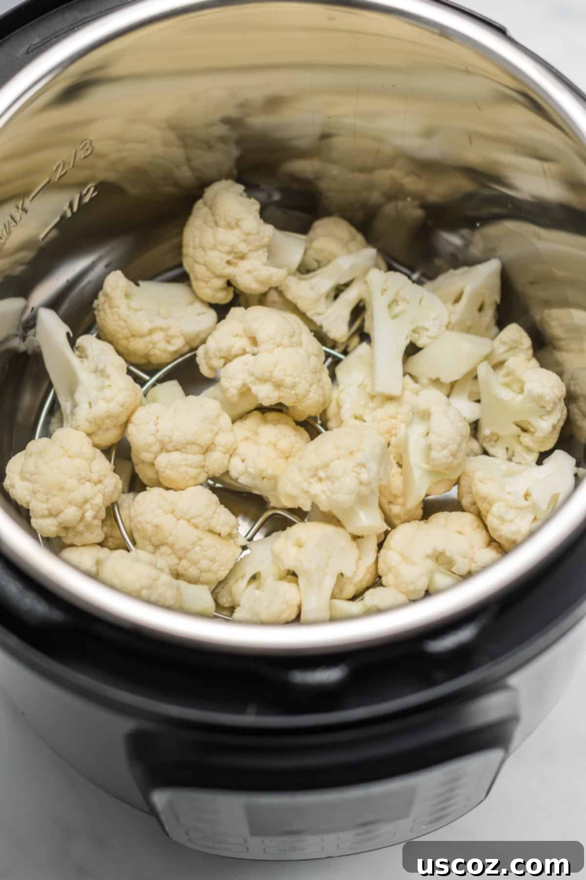 Easy Instant Pot Cauliflower 4 raw cauliflower florets inside an instant pot