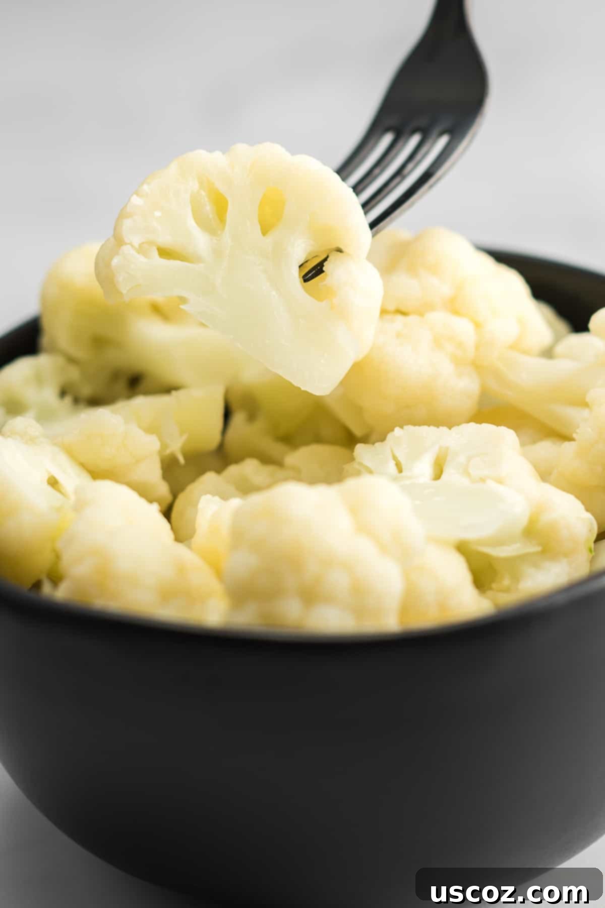 Easy Instant Pot Cauliflower 9 fork taking a floret of cauliflower from a bowl
