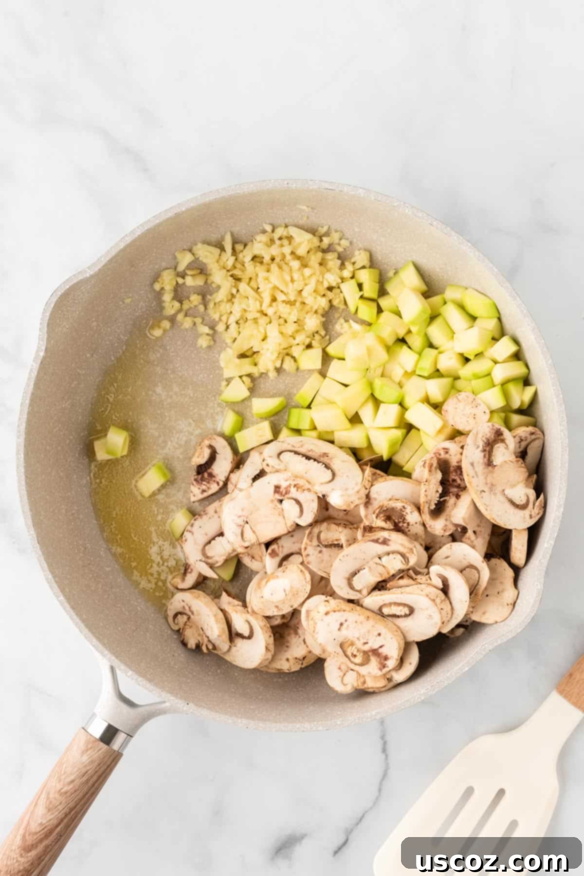 Cheesy Tortellini Bake 4 mushrooms, garlic, and zucchini cooking in a skillet