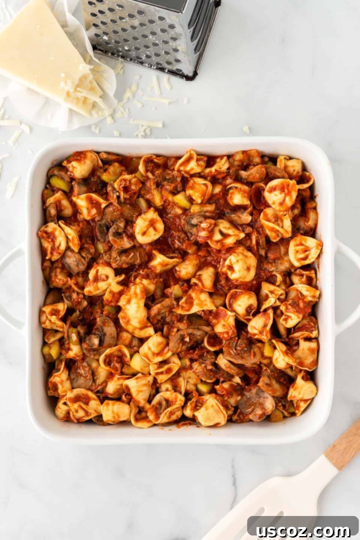 Cheesy Tortellini Bake 8 transferring the tortellini mixture into a greased baking dish