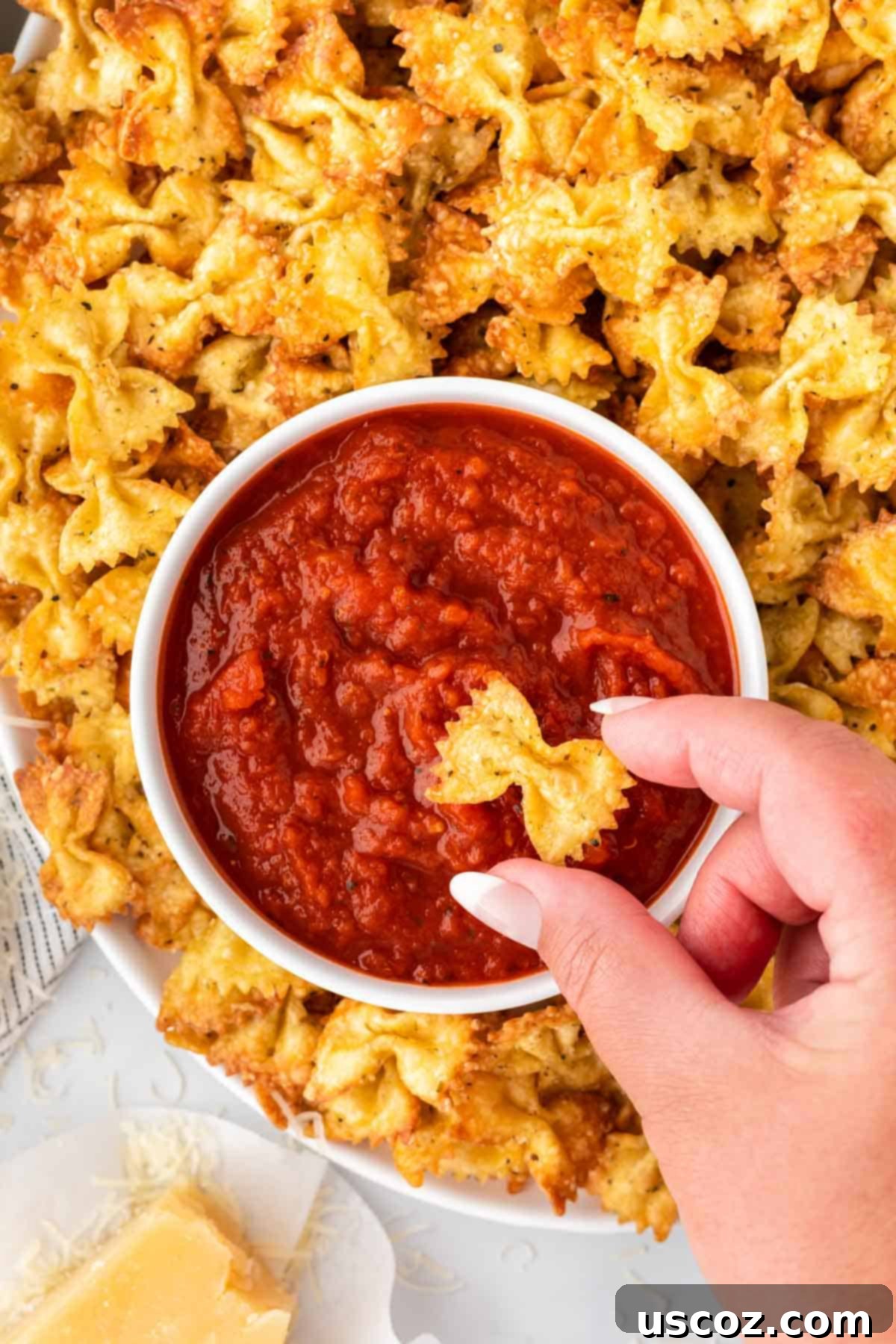 Crispy Air Fryer Pasta Chips 2 Crispy air fryer pasta chips served with a bowl of marinara for dipping, presented as an irresistible snack or appetizer.