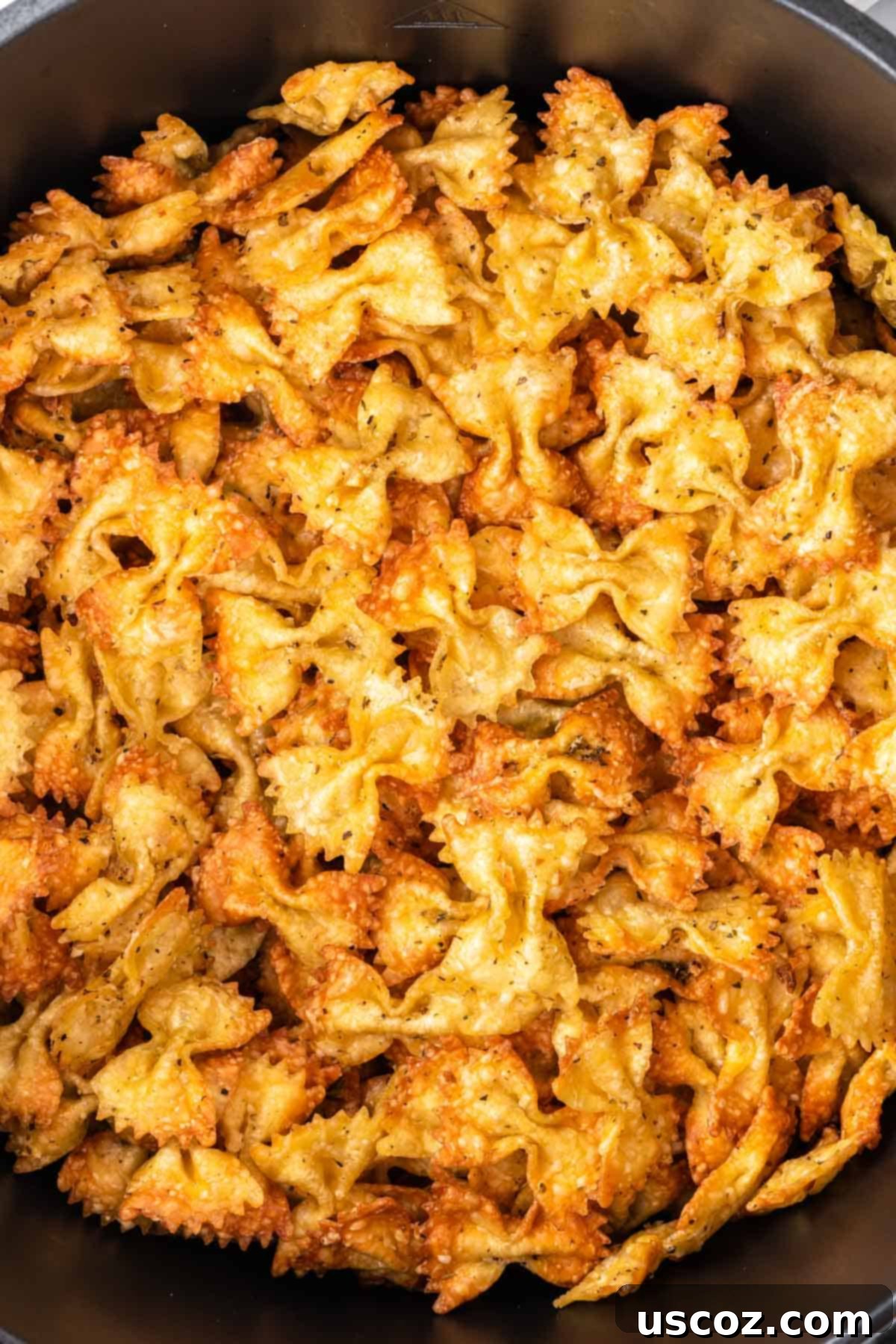 Crispy Air Fryer Pasta Chips 11 A close-up of a batch of perfectly crispy, golden-brown air fryer pasta chips, just removed from the air fryer.
