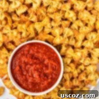 Crispy Air Fryer Pasta Chips 16 Crispy air fryer pasta chips served with a bowl of marinara for dipping.