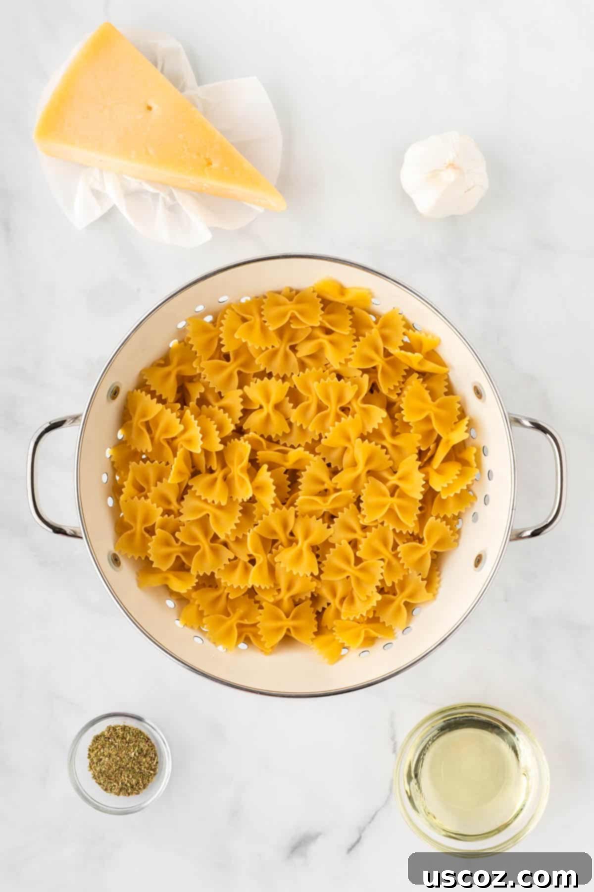 Crispy Air Fryer Pasta Chips 4 A selection of fresh ingredients laid out, including bowtie pasta, minced garlic, Italian seasoning, olive oil, and parmesan cheese, ready for making air fryer pasta chips.
