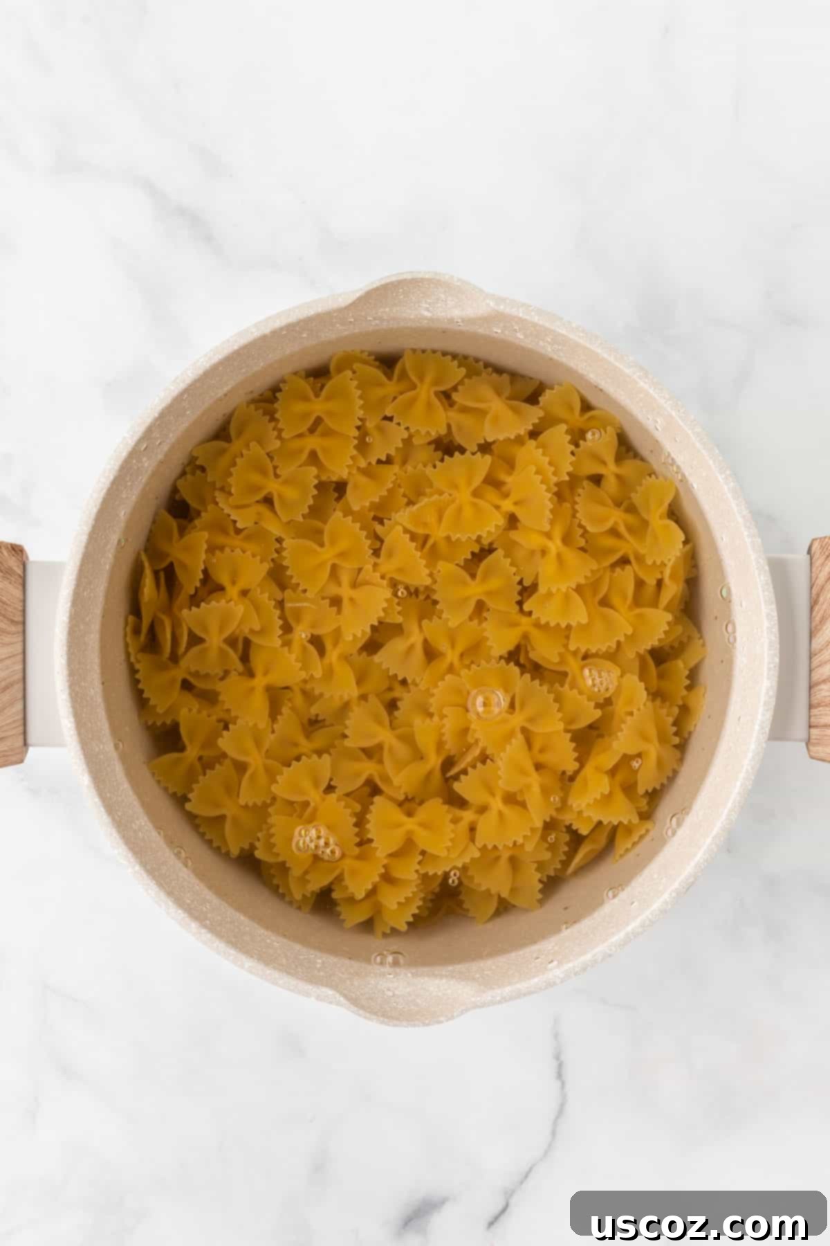 Crispy Air Fryer Pasta Chips 5 Bowtie pasta being cooked in a saucepan of boiling water until al dente.