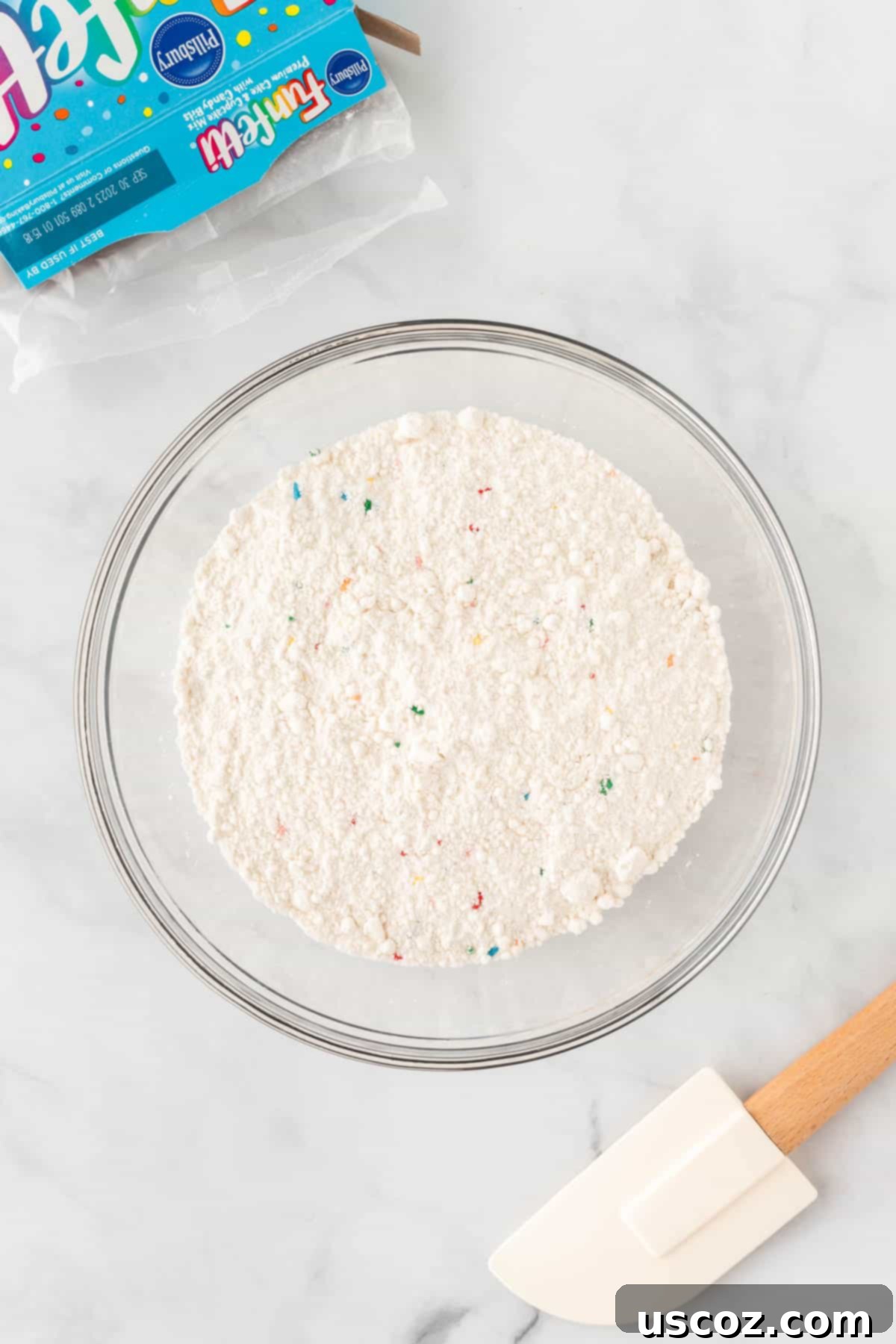 Effortless Rainbow Cake Cookies 5 A bowl filled with funfetti cake mix, ready for additional ingredients.