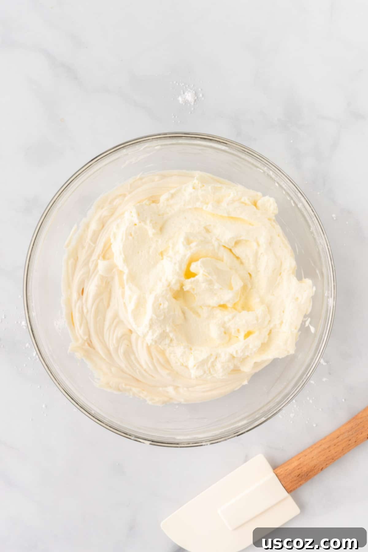 Creamy No-Bake Cheesecake Bliss 11 gently mixing whipped cream and cream cheese together for the filling
