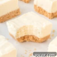 Creamy No-Bake Cheesecake Bliss 20 cheesecake bar with a bite taken out, showing creamy filling