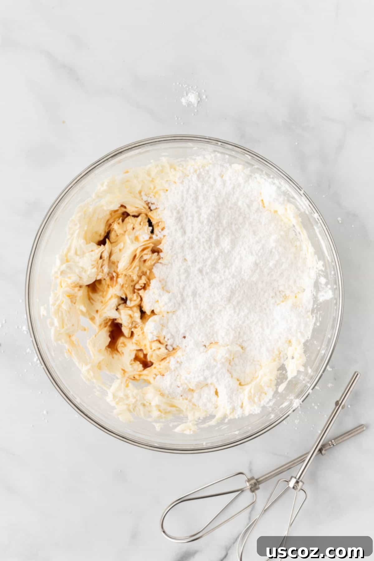 Creamy No-Bake Cheesecake Bliss 10 adding powdered sugar to the fluffy whipped cream cheese mixture