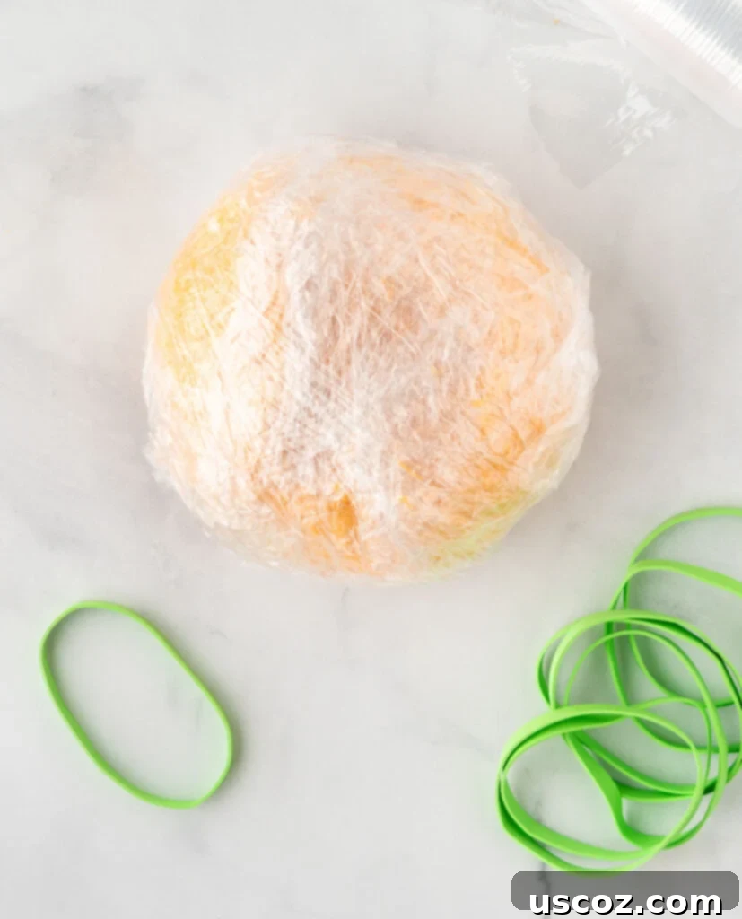 Spiced Pumpkin Cheese Ball 11 cheese ball wrapped in saran wrap