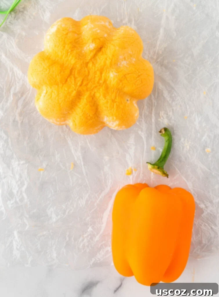 Spiced Pumpkin Cheese Ball 13 removing a stem from a bell pepper to place on the cheese ball