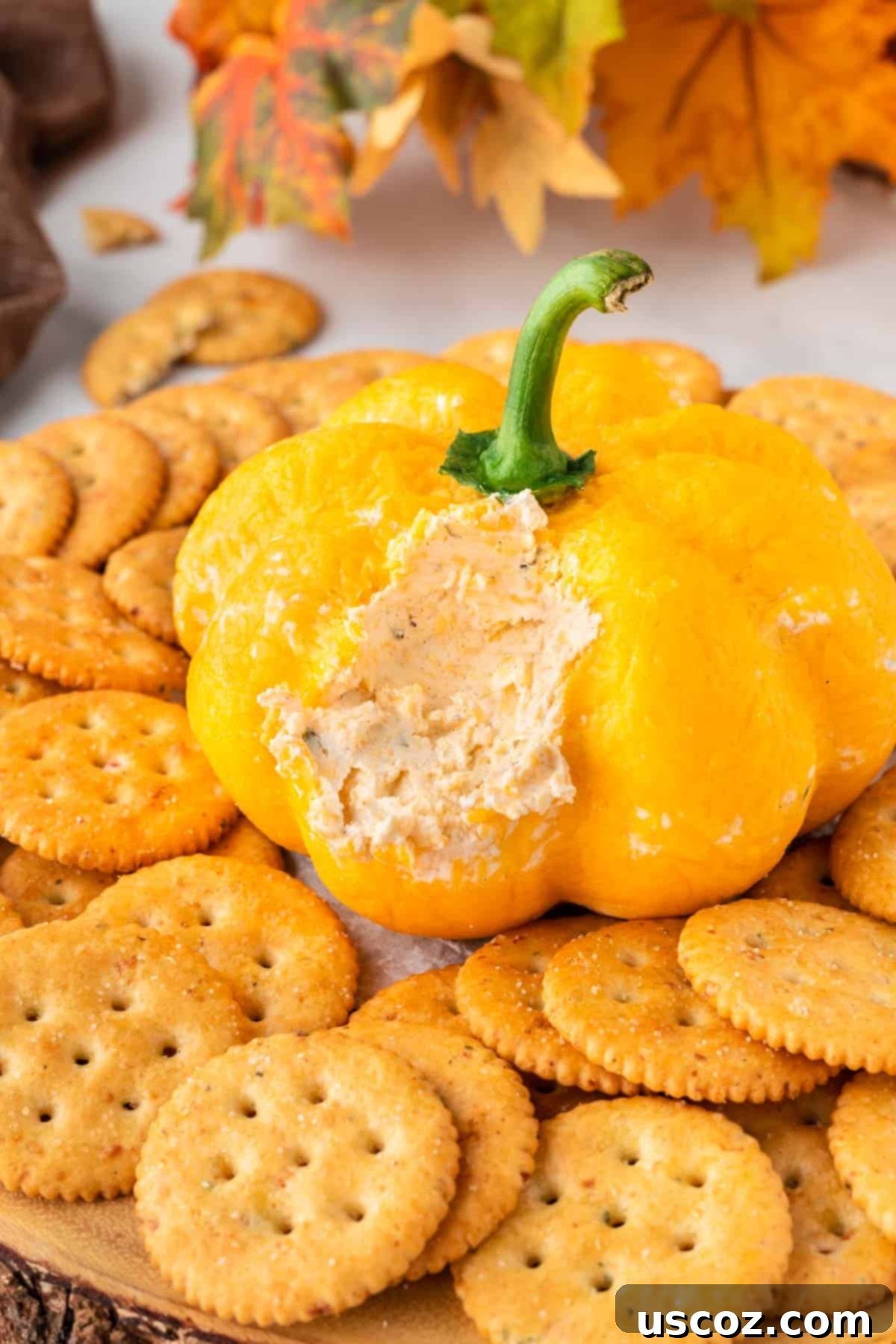 Spiced Pumpkin Cheese Ball 3 cheese ball cut open to show the creamy cheese dip filling
