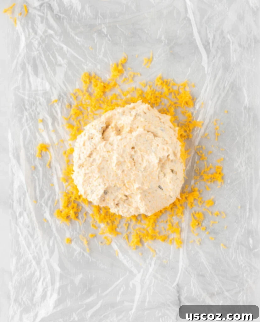 Spiced Pumpkin Cheese Ball 8 cheese ball placed over the cheddar cheese