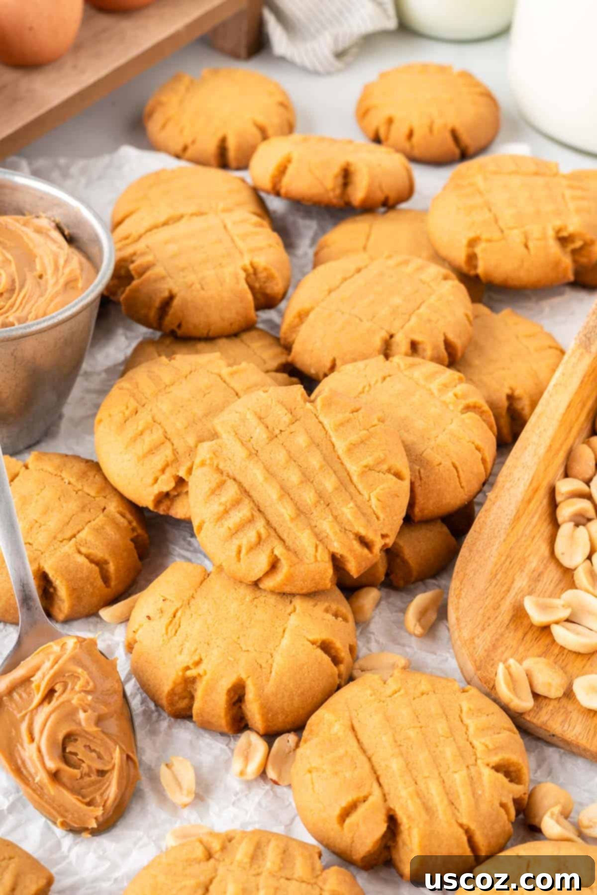 Easy Cake Mix Peanut Butter Cookies 13 A large pile of soft and chewy peanut butter cookies, showcasing their golden color and criss-cross pattern.
