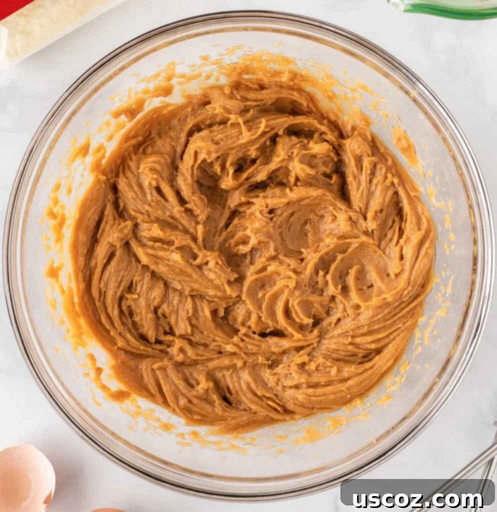 Easy Cake Mix Peanut Butter Cookies 6 The eggs, oil, and peanut butter are now fully mixed into a smooth, creamy batter.