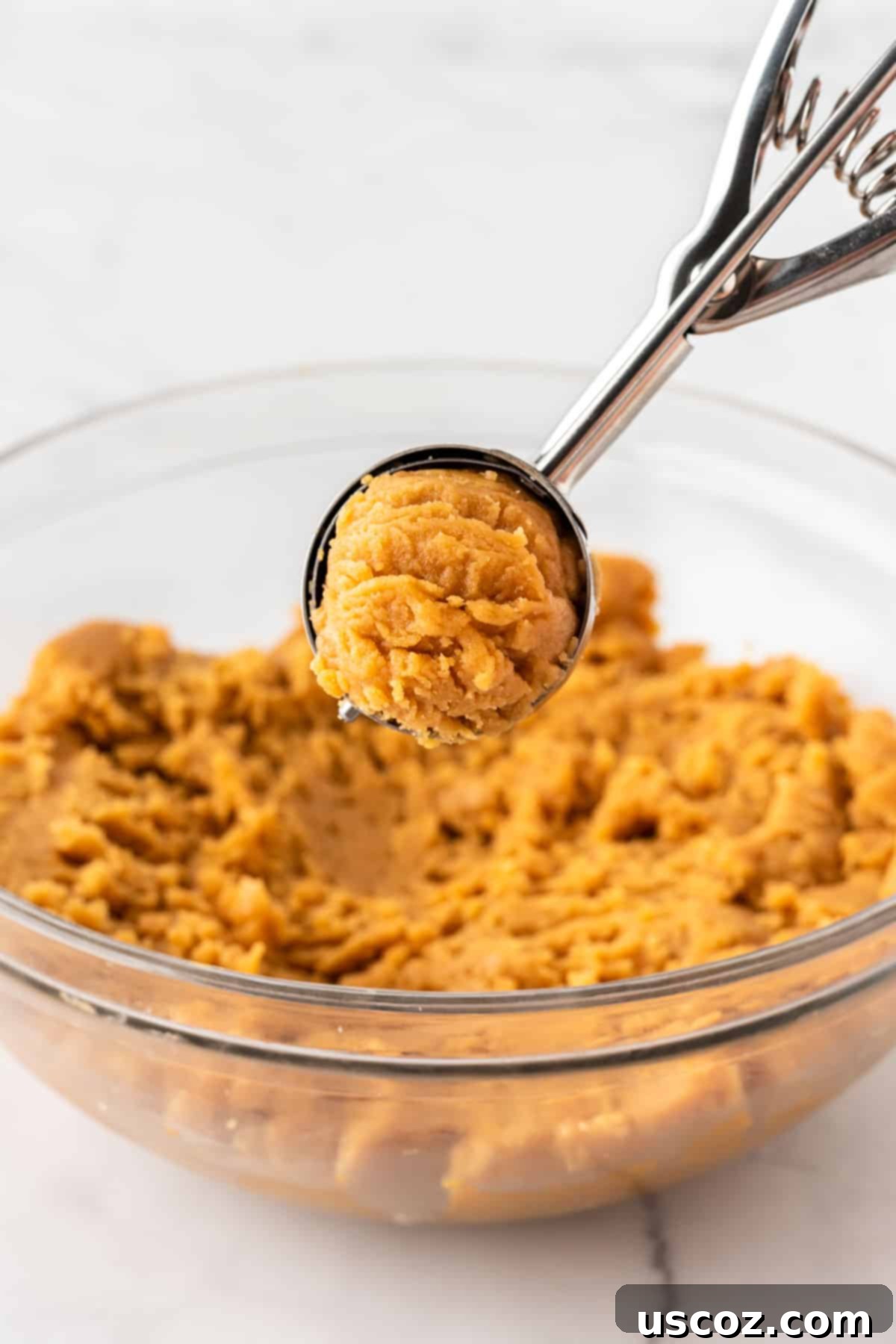 Easy Cake Mix Peanut Butter Cookies 9 A mini cookie scoop full of peanut butter cookie dough, perfectly portioned.