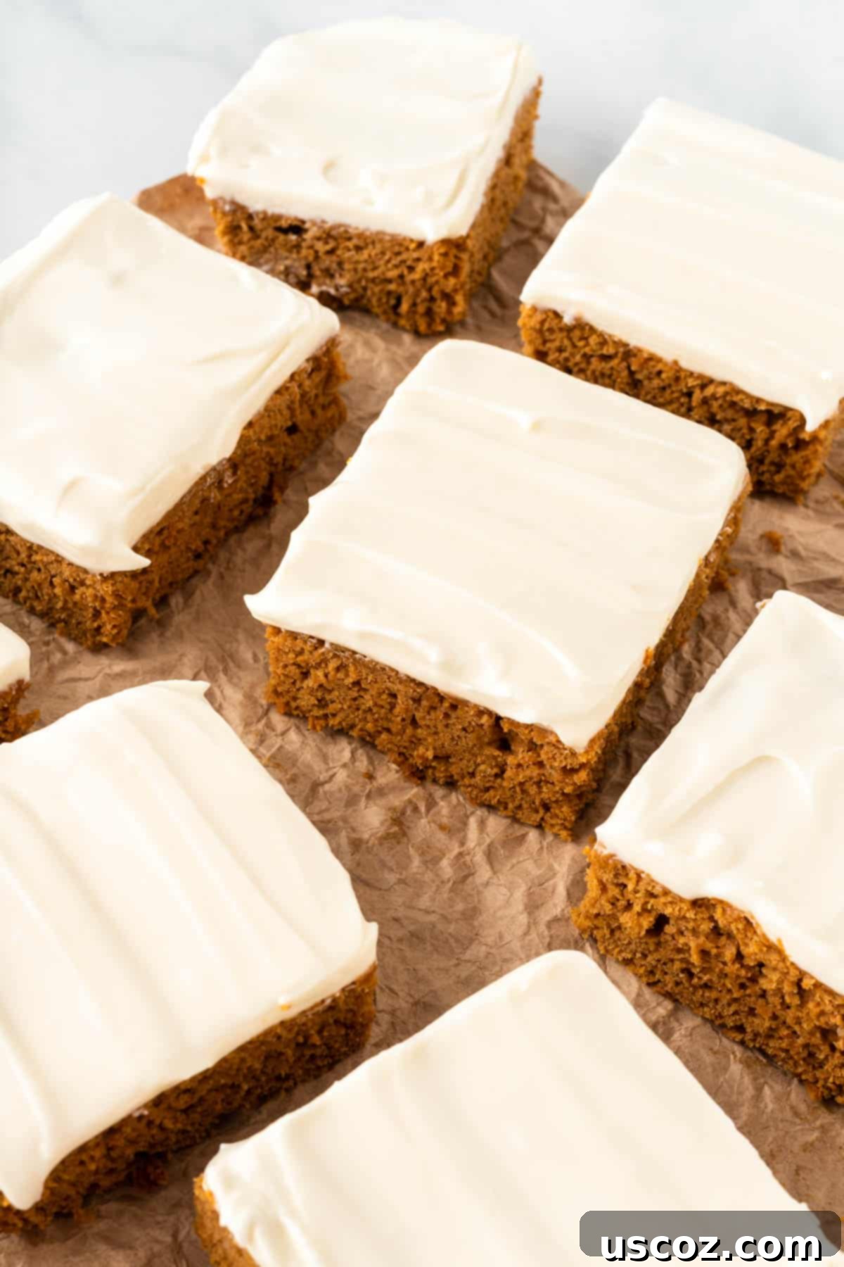 Easy Cake Mix Pumpkin Bars 13 close-up of a single cake mix pumpkin bar with cream cheese frosting, garnished with a sprinkle of cinnamon