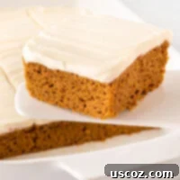 Easy Cake Mix Pumpkin Bars 14 taking a pumpkin bar from the pan