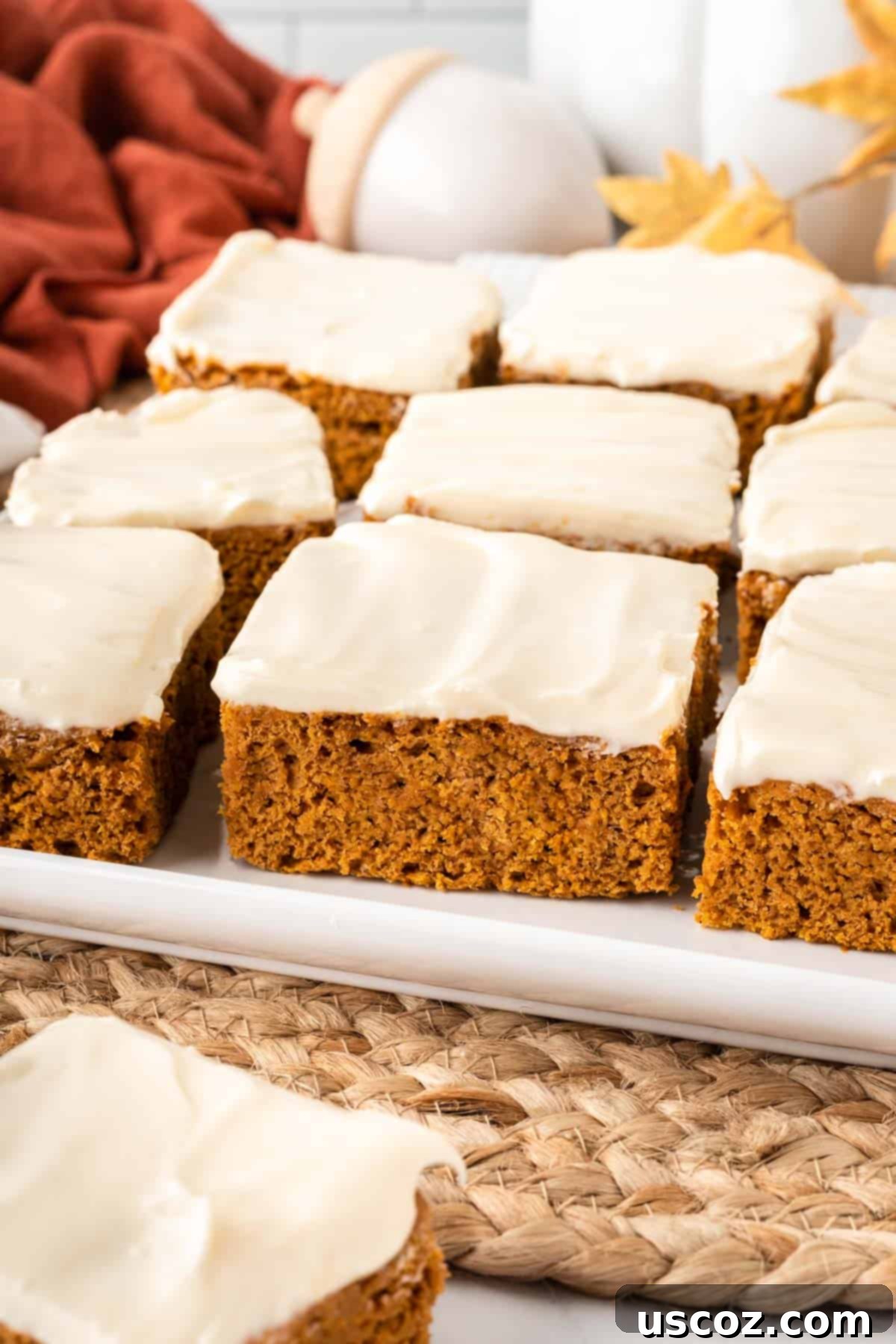 Easy Cake Mix Pumpkin Bars 3 close-up of a cake mix pumpkin bar with cream cheese frosting, ready to be enjoyed