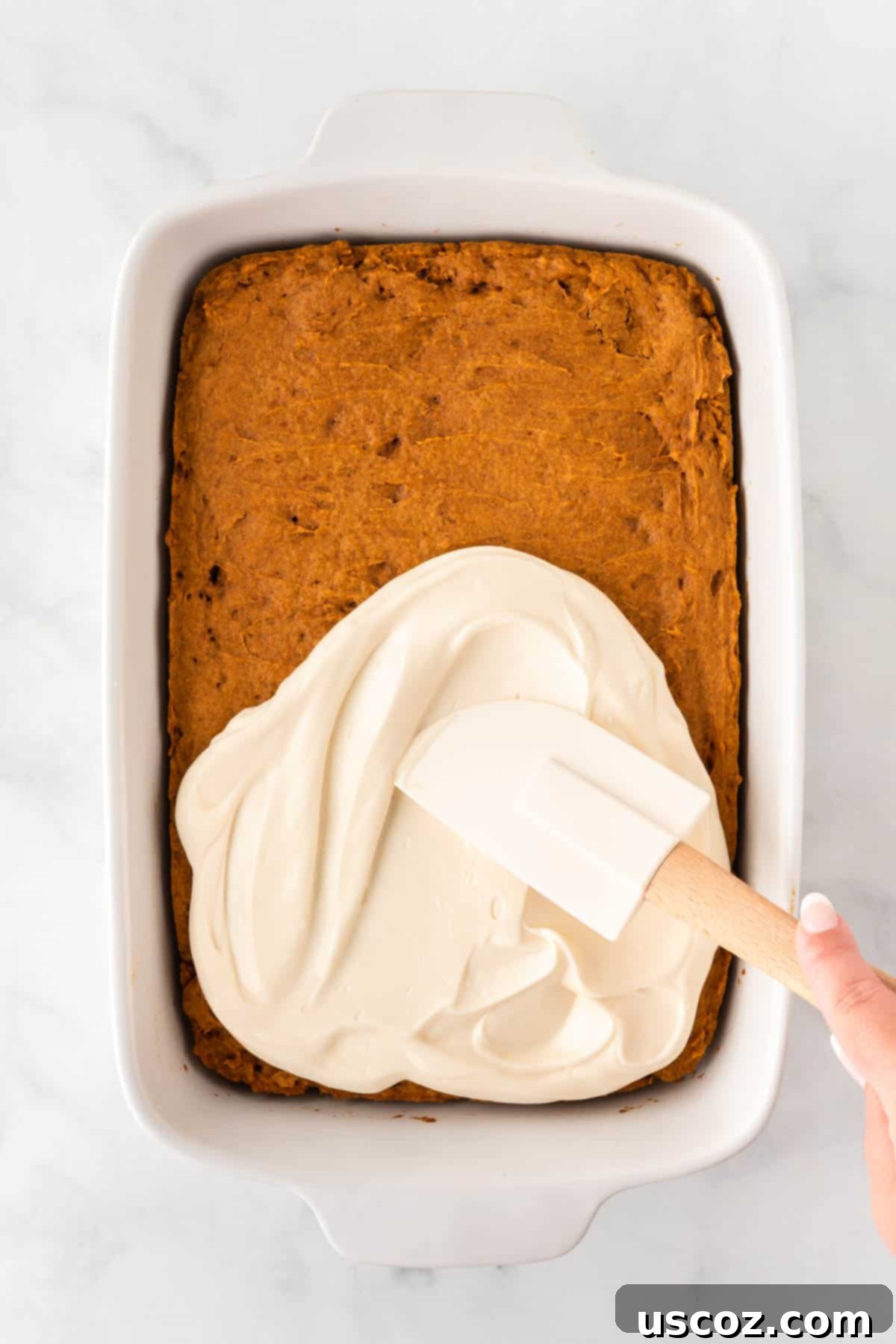 Easy Cake Mix Pumpkin Bars 9 spreading cream cheese frosting evenly over the cooled pumpkin bars