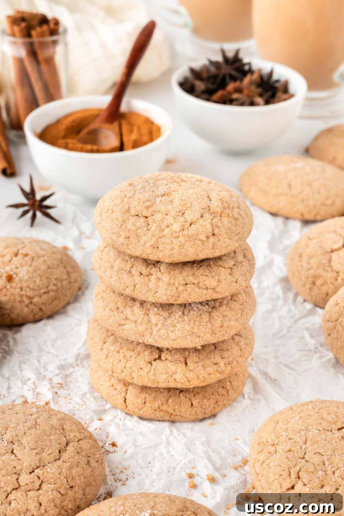 Quick Cake Mix Spice Cookies 3 Stacked chewy cake mix spice cookies on a white plate, garnished with a sprig of cinnamon sticks.