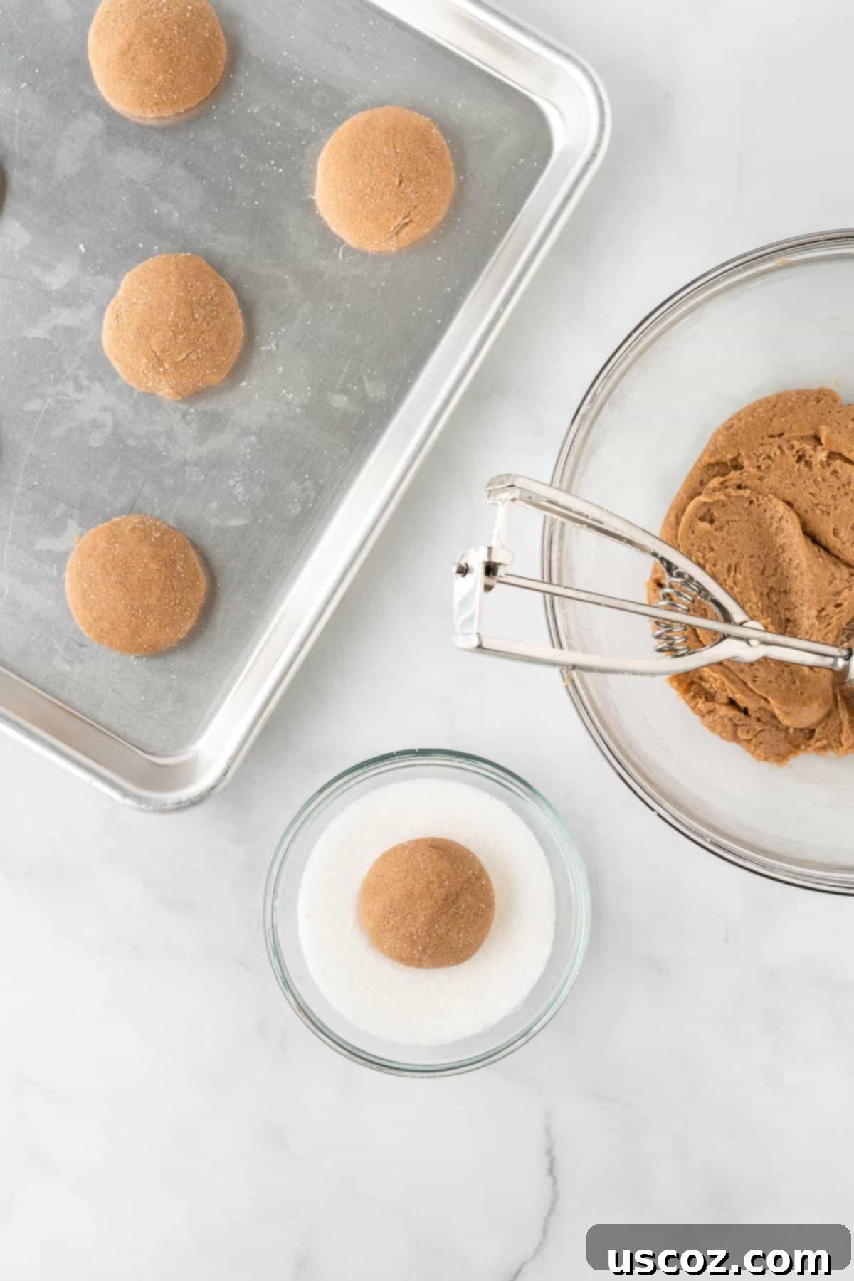 Quick Cake Mix Spice Cookies 8 A hand rolling a ball of spice cookie dough in a bowl of coarse granulated sugar.