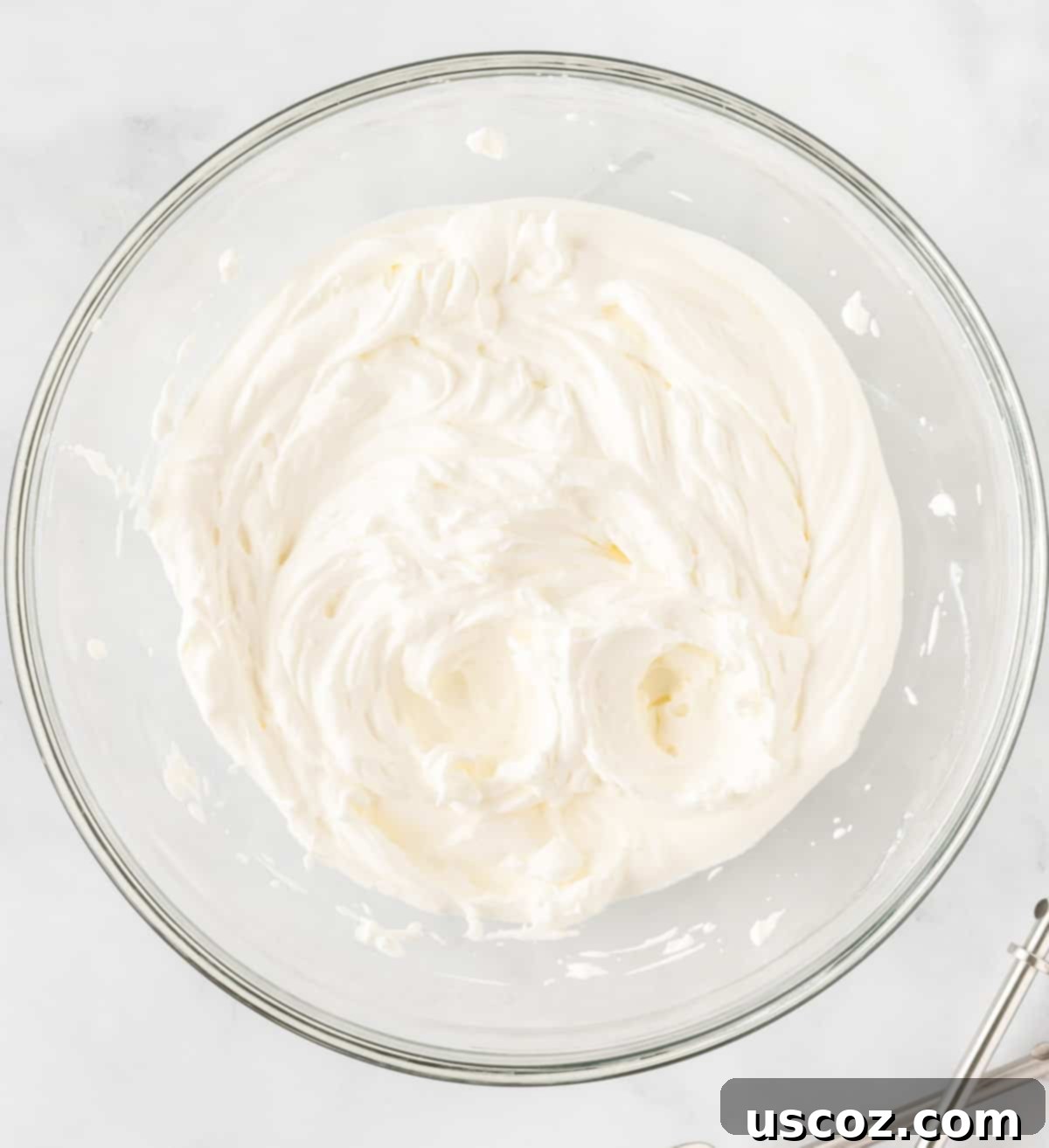 Easy No-Bake Pumpkin Cheesecake Bars 11 creamy pumpkin cheesecake filling mixed in a bowl, before adding whipped cream