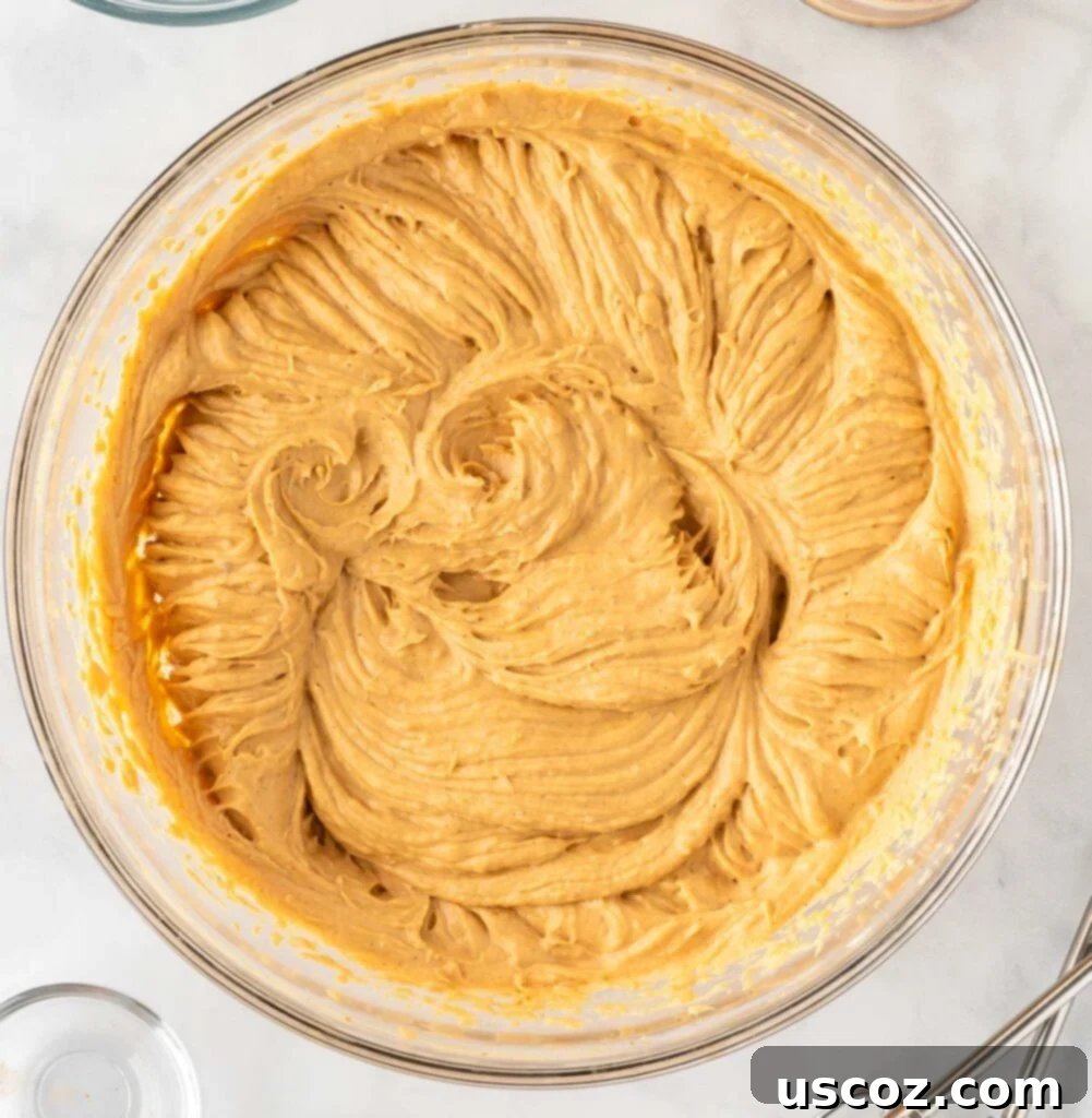 Easy No-Bake Pumpkin Cheesecake Bars 12 whipped cream being folded into the pumpkin cream cheese mixture